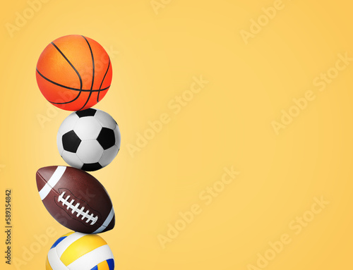 Stack of different sport balls on gold background  space for text