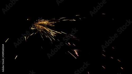 Industrial backdrop with sparks flying on a black background, concept of metal working and blacksmithing photo