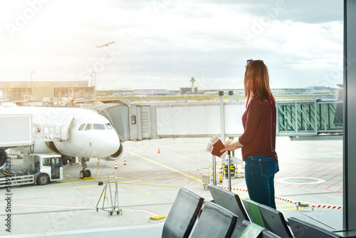 Fotografie Woman at the airport window and flight departure, Airport Terminal: Happy Traveling Looks Around, Wondering on Vacation