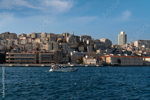 View of the embankment-boulevard of the Galataport shopping and entertainment center in the Karakey area and the Cihangir Mosque on a sunny day, Istanbul, Turkey