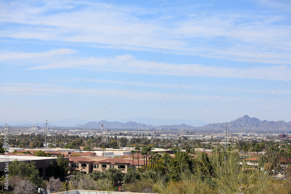 Arizona capital city of Phoenix as seen from a rooftop across south part of Valley of the Sun toward North-East mountains