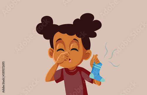 Little Girl Holding a Stinky Dirty Sock Vector Cartoon Illustration. Funny child pinching her nose disgusted by dirty laundry 
