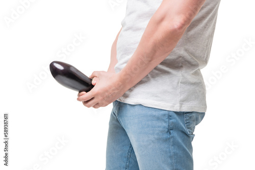 Guy crop view holding eggplant at crotch level imitating penis erection isolated on white