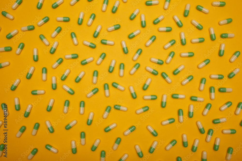 Filled background of green-yellow capsules which are located separately from each other