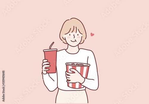Girl  holding plastic cup of cola or soda bucket of popcorn. Hand drawn style vector design illustrations.