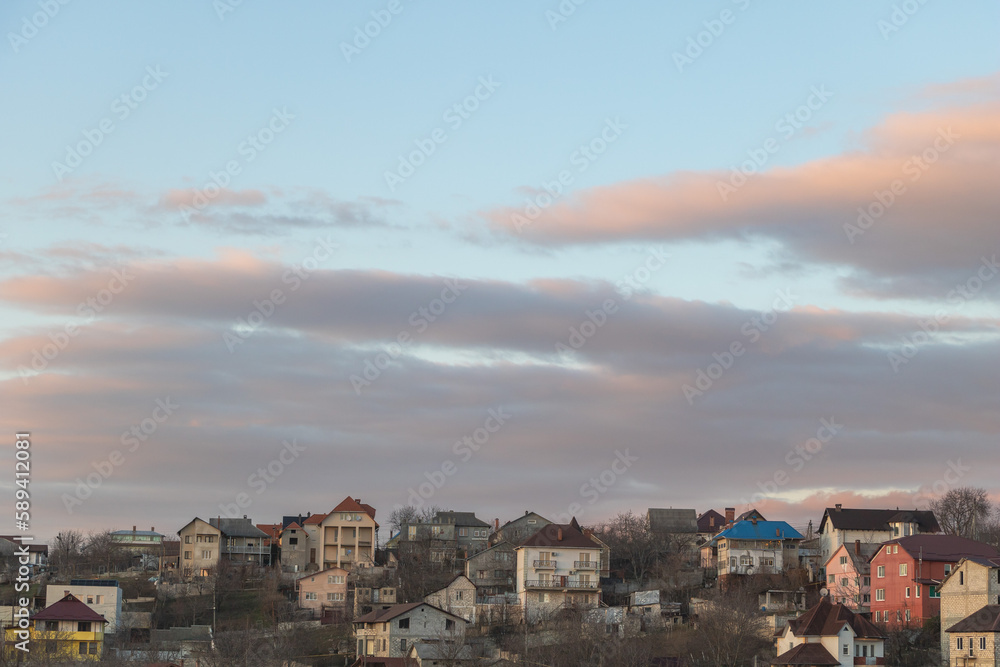 Cityscape of the city in the evening with clouds in the sky