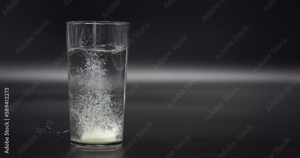 effervescent the tablet is thrown into a transparent glass beaker with water. effervescent the tablet is thrown into a transparent glass beaker with water.