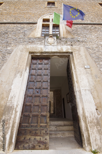 Capestrano (AQ) - Abruzzo - Italy - -The large entrance door of the Piccolomini Castle of Capestrano, you can see the flag of Italy and Europe photo