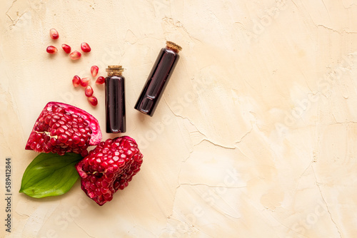 Pomegranate fruit and leaves and bottle of pomegranate seed oil