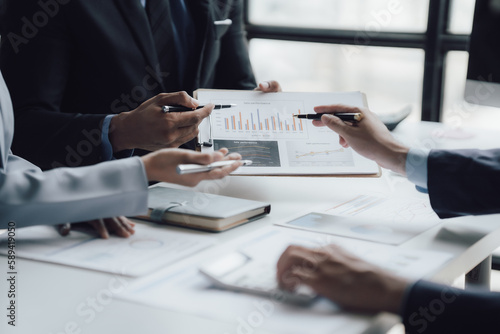 Fototapeta Naklejka Na Ścianę i Meble -  business adviser meeting to analyze and discuss the situation on the financial report in the meeting room.Investment Consultant, Financial advisor and accounting concept