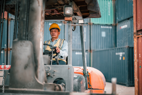 Senior container controllers navigate and drive folklift to transfer, deliver and drop-off merchandise. An equitable work environment in which employees of various ages feel included and valued. photo