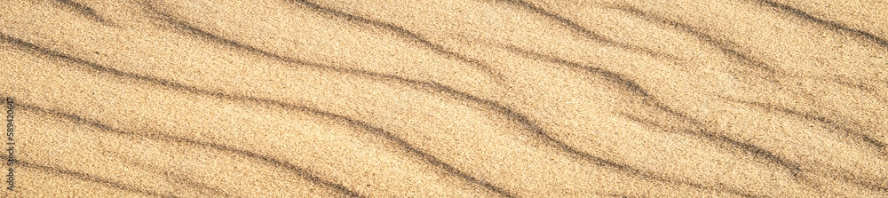 banner of closeup of sand pattern of a beach in the summer. Vacation and sea travel background