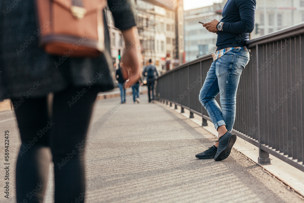 Man standing by railing and using smart phone Man standing by railing and using smart phone