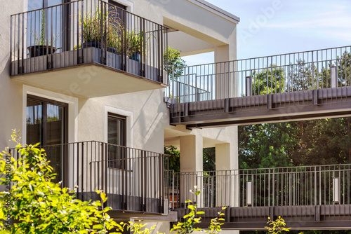 Modern Balcony and Entrance to Terrace with Metal Railing on Second Floor of Residential Apartment Building. Bridge Terrace or Passage between Houses.  photo