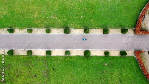 Aerial top-down tracking shot of cyclist in a city park, Scotland photo