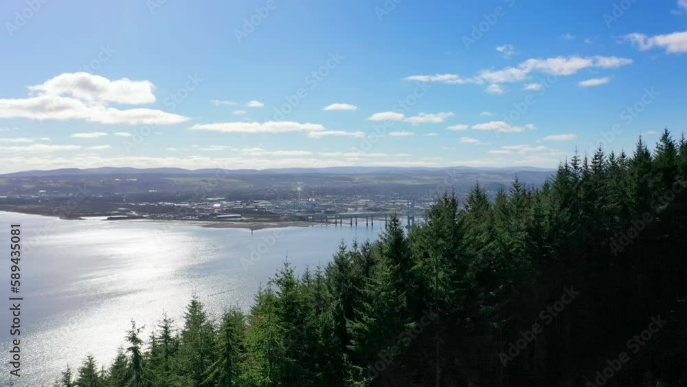 Aerial shot rising over forest to reveal Inverness, Scotland Aerial shot rising over forest to reveal Inverness, Scotland