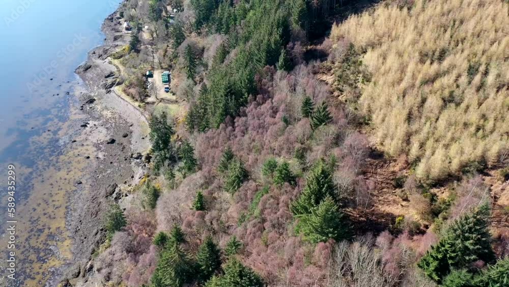 Rotating aerial shot of coastal forest in the Highlands, Scotland Rotating aerial shot of coastal forest in the Highlands, Scotland