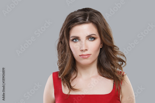 Portrait of beautiful brunette. Nice woman with makeup looking at camera on white background