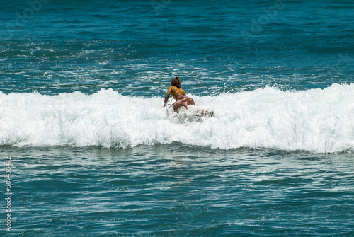Surfers on waves, in Canggu, Bali Island, Indonesia