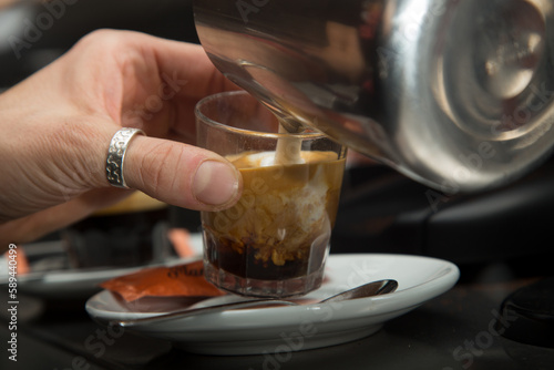 Barista preparing a delicious organic coffee. Flat white or cortado. © Leckerstudio