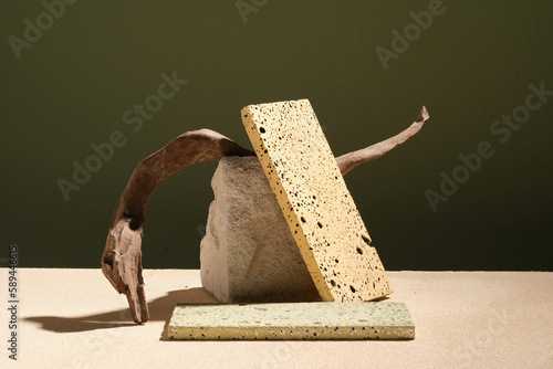 Fototapeta Naklejka Na Ścianę i Meble -  Front view of a block of stone with a rectangle pedestal leaning on, tree branch displayed. Empty podium for product advertising