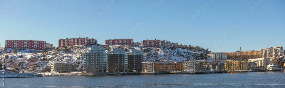 Apartments on a cliff and at the waterfront in the district Nacka, a sunny spring day in Stockholm