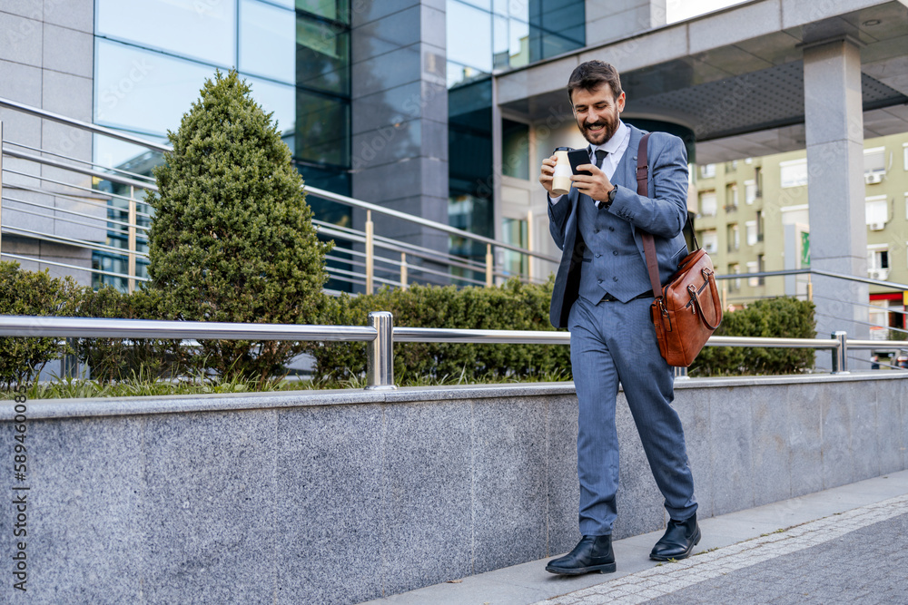 Businessman using mobile phone outside of office