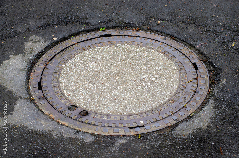 Manhole sewer in Germany on the road Manhole sewer in Germany on the road