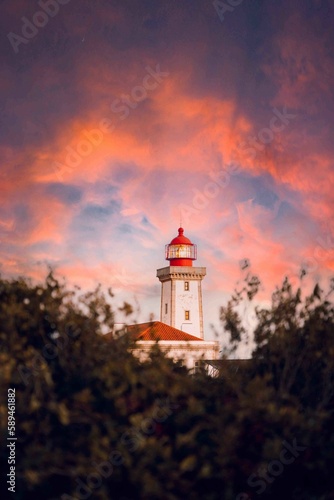 Lighthouse against a sunset © Ula3/Wirestock Creators