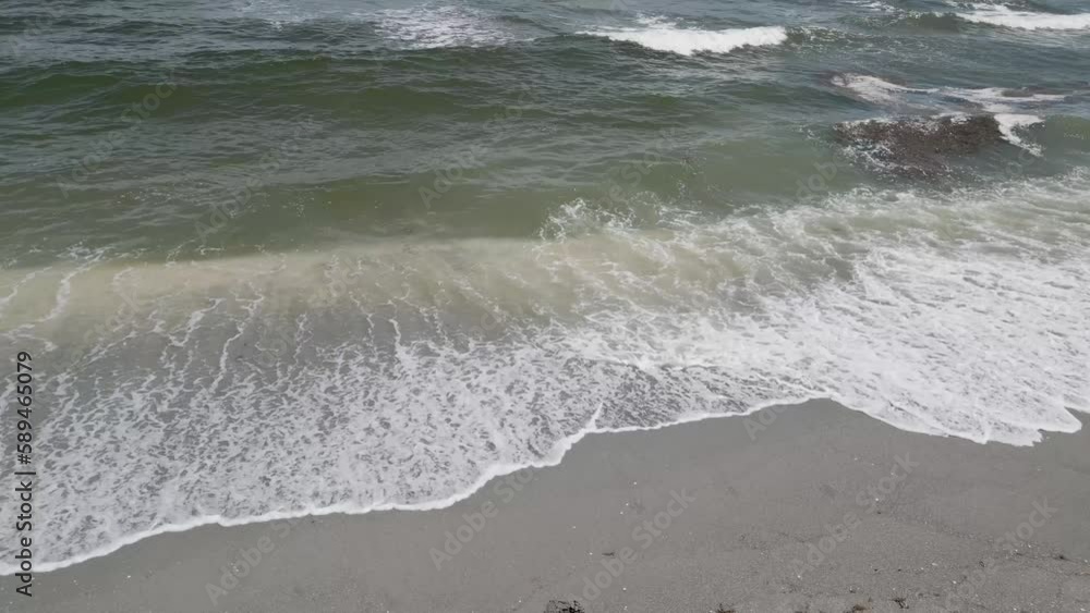 Aerial shot of the waves of the Atlantic Ocean washing off the beach Aerial shot of the waves of the Atlantic Ocean washing off the beach