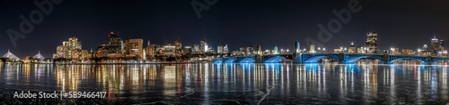 an artistic picture of water and the city at night with some lights on