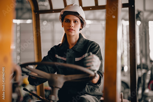 A female robotic technician operates the folklift and schedules regular maintenance and repairs. A gender-neutral workplace in which all employees are honored and respected with low discrimination photo