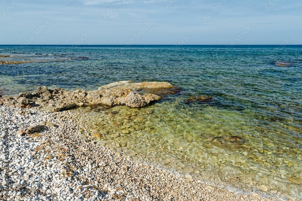Beautiful view of small pebble stones on the Costa Blanca coastline in the Alicante province, Spain Beautiful view of small pebble stones on the Costa Blanca coastline in the Alicante province, Spain
