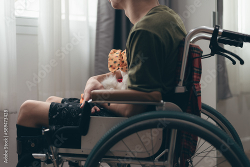 Canvastavla Man with disability hug toy doll think alone,Teenager boy looking through the window of the  in Healthcare,Mental health affected during the quarantine,Sad emotional,loneliness,depression concept