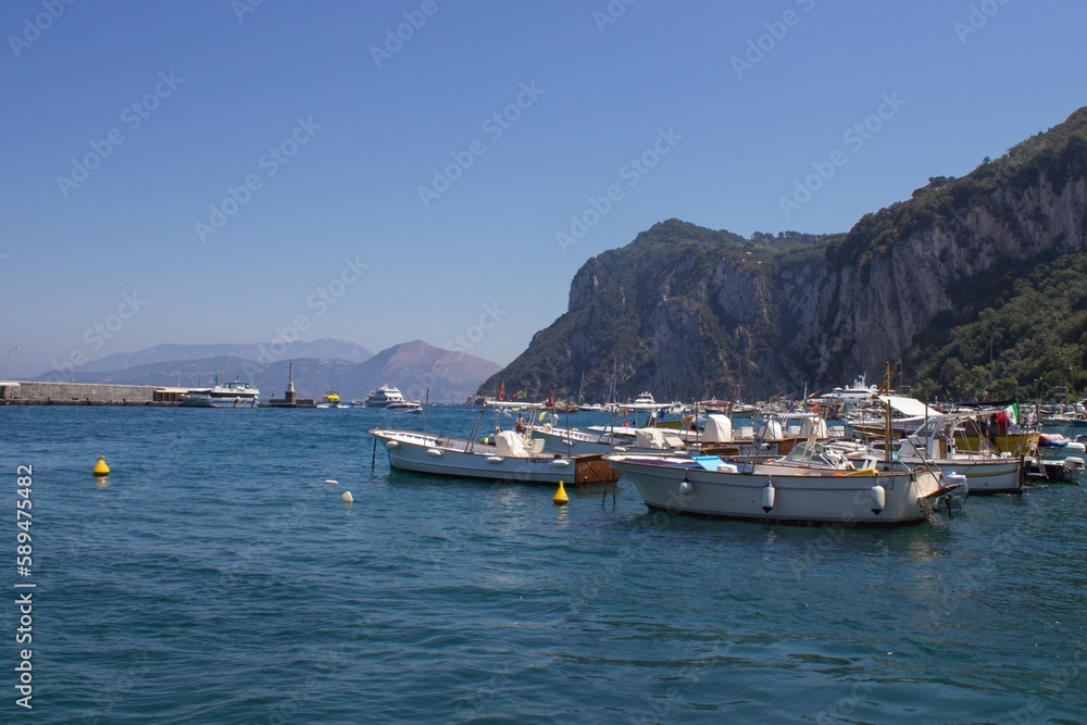 Beautiful shot of boats along the beautiful shore of Capri Island, Naples, Italy
