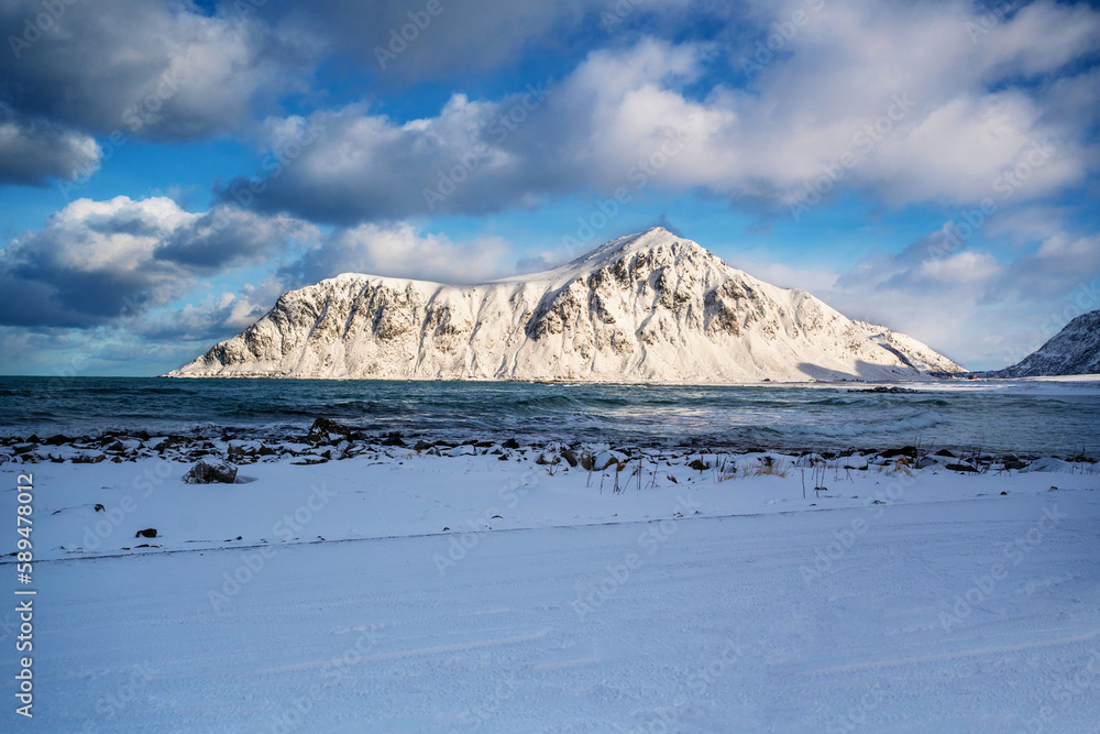 Snowy landscape and mountain on arctic Skagsanden beach