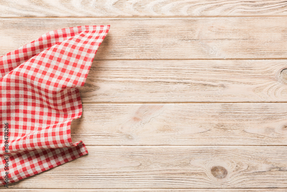 Obraz premium top view with red empty kitchen napkin isolated on table background. Folded cloth for mockup with copy space, Flat lay. Minimal style