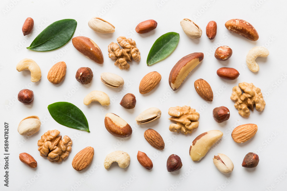 Composition of nuts , flat lay - mix hazelnuts, cashews, almonds on table background. healthy eating concepts and food background Composition of nuts , flat lay - mix hazelnuts, cashews, almonds on table background. healthy eating concepts and food background