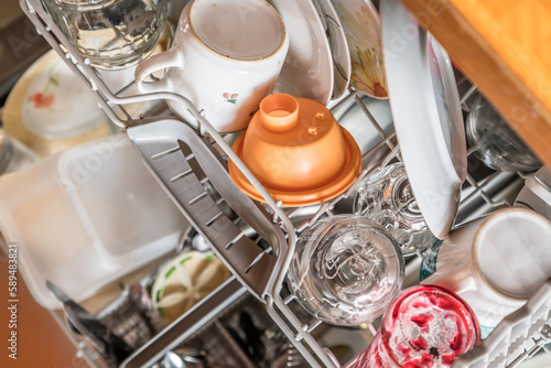 Nahaufnahme einer voll eingeräumten vollen bestückten Spülmaschine in einer Küche mit Geschirr Gläser Schüsseln Messer Gabel Löffel Besteck, Deutschland