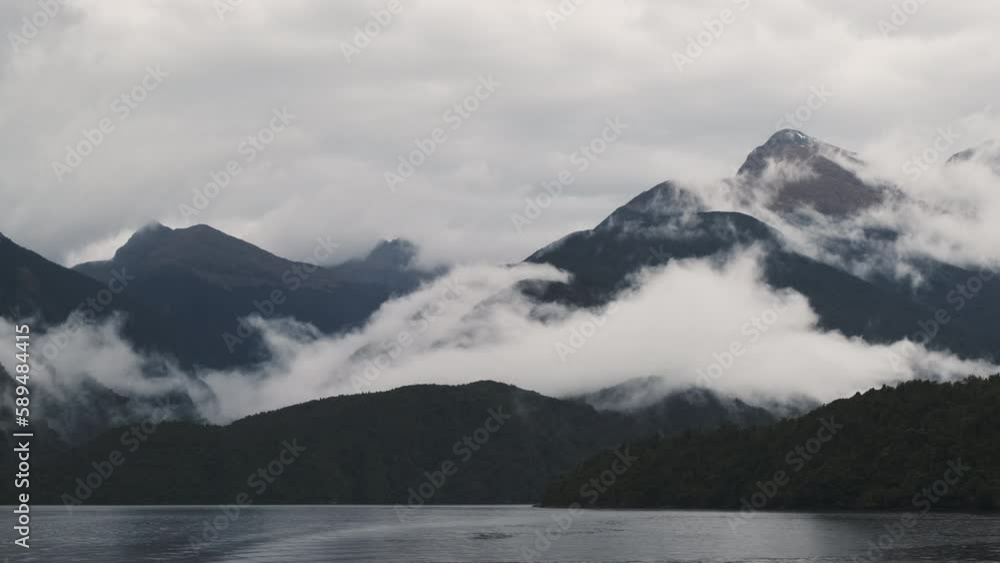 clouds and mountains over a body of water in cloudy weather clouds and mountains over a body of water in cloudy weather
