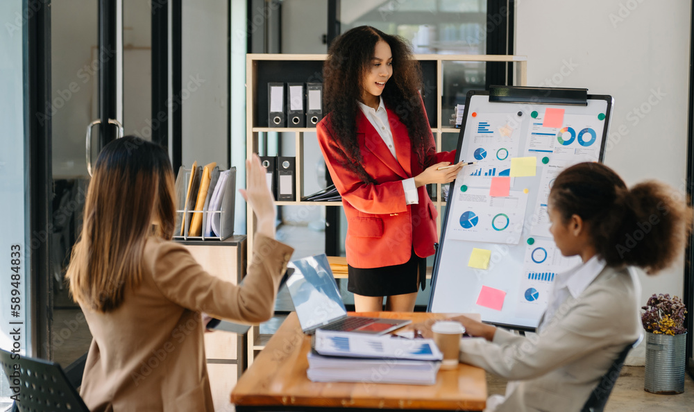Business African women work and discuss their business plans. A Human employee explains and shows her colleague the results paper in office.. Business African women work and discuss their business plans. A Human employee explains and shows her colleague the results paper in office..