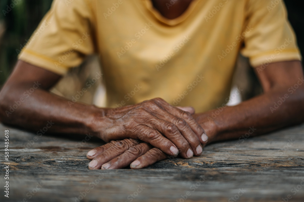 Close up of male wrinkled hands, old man is wearing  ..