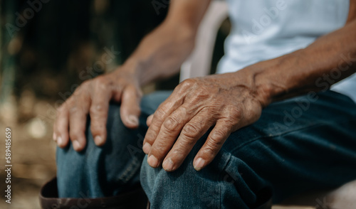 Fotografie Close up of male wrinkled hands, old man is wearing  ..