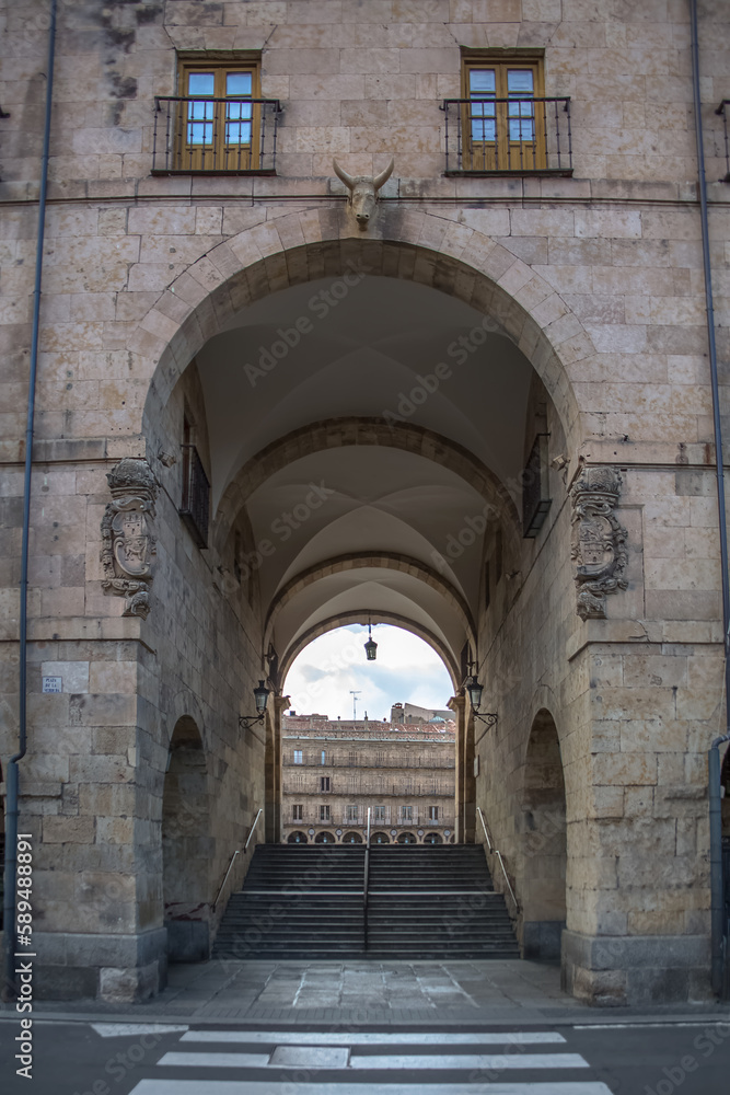 View at the bull gate or arco del toro , on Salamanca downtown city, passage and staircase to iconic Plaza Mayor