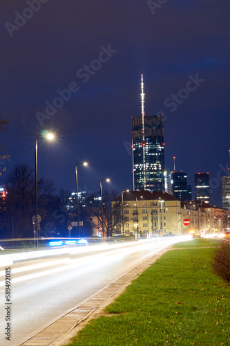 Widok nocą na centrum Warszawy od strony Mokotowa z poziomu drogi z widocznym najwyższym budynkiem w mieście i UE photo