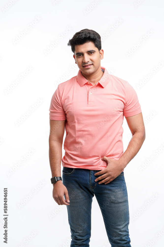 Fototapeta premium Young Indian man wearing basic t-shirt standing and holding hands in pockets.