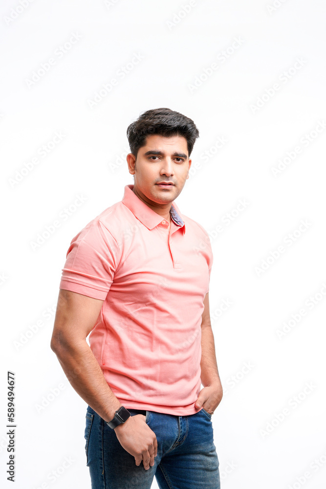 Fototapeta premium Young Indian man wearing basic t-shirt standing and holding hands in pockets.