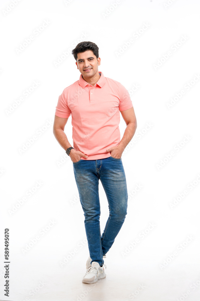 Fototapeta premium Young Indian man wearing basic t-shirt standing and holding hands in pockets.