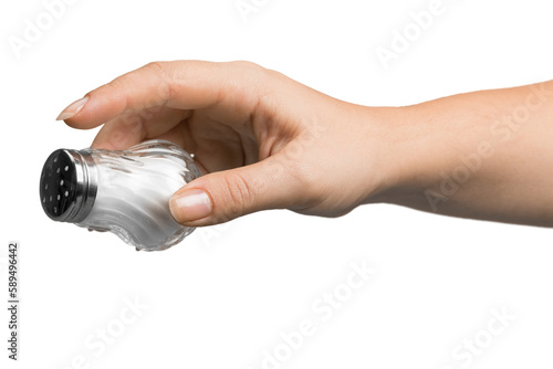 Female hand pouring salt from salt shaker on white background photo