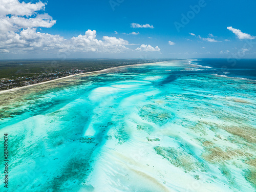 Aerial view of white coral sand of a blue lagoon at low tide, Paje, Jambiani, Zanzibar, Tanzania photo